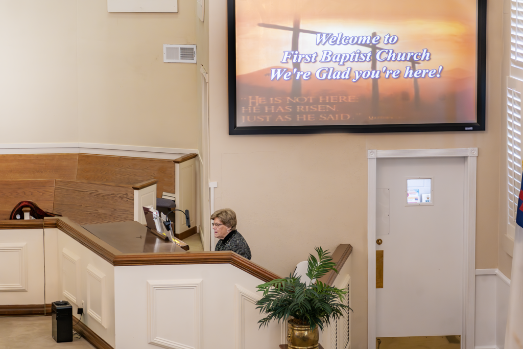 Lady playing the organ at a church. 